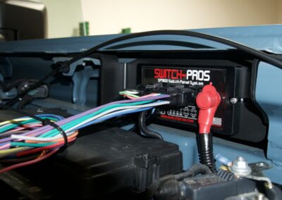 Heavy-duty Switch-Pros control panel behind car dashboard, vehicle power management system, multi-circuit switch.