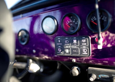 High-performance Switch-Pros control panel with switches and gauges for vehicle power management.
