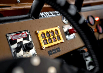 Bright yellow switch panel for off-road vehicle lighting and accessories with digital controls.